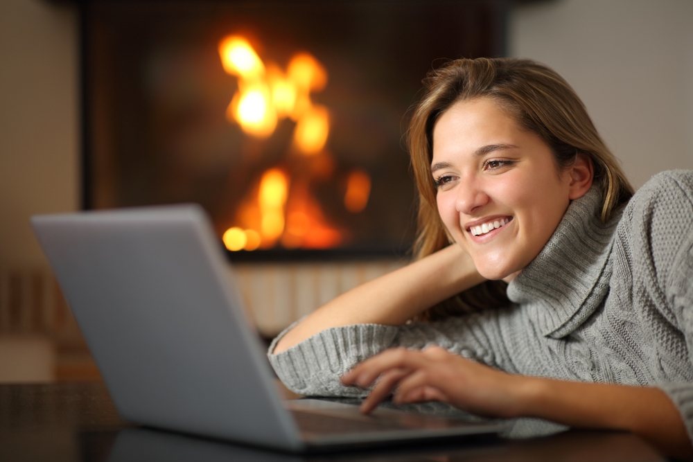 Happy,Woman,Using,Laptop,Watching,Media,Content,At,Home,Near