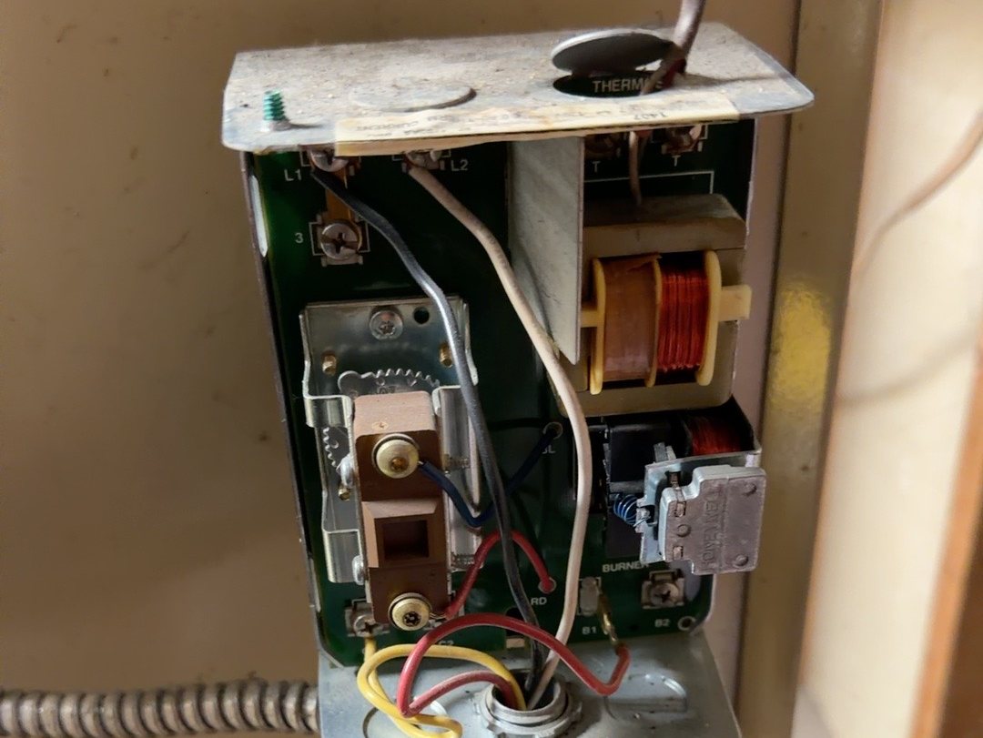 Before: an old boiler aquastat with its cover off