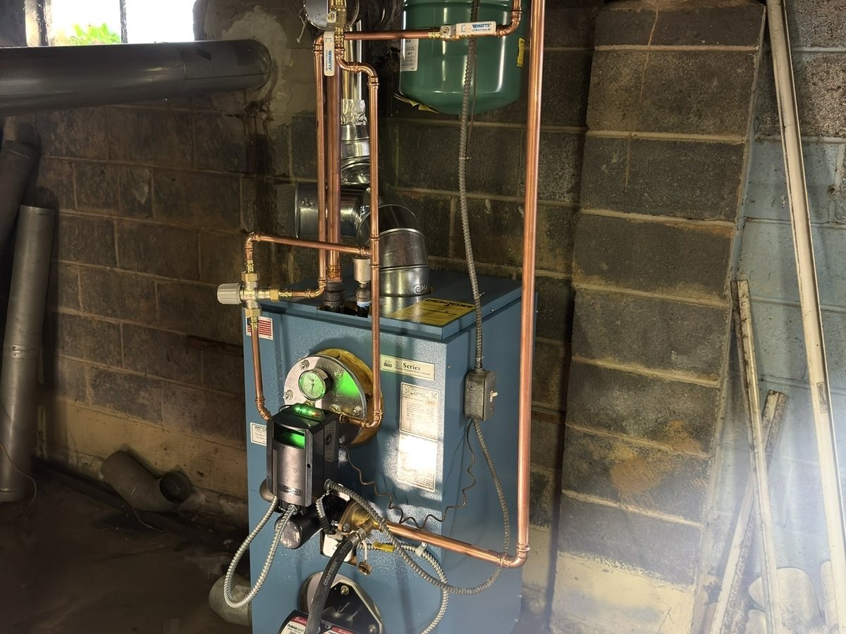 Newly installed blue boiler with new copper piping