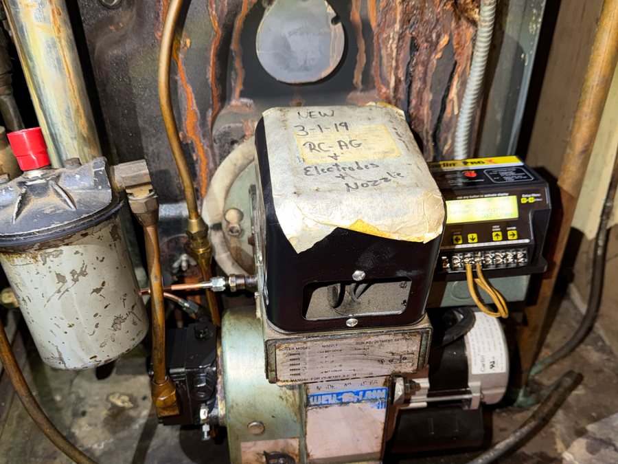 Older oil burner and controls on a boiler