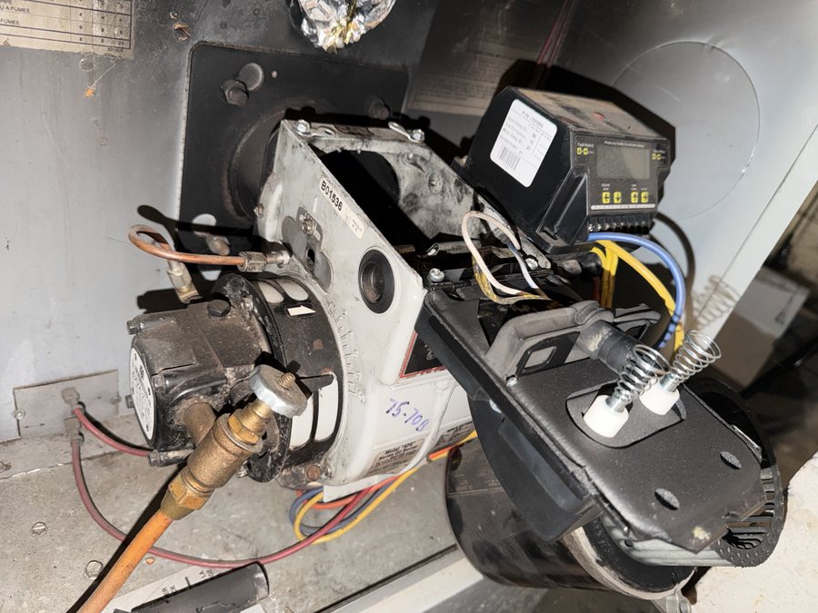 Oil burner with the electrodes out and the blower open during a tune-up