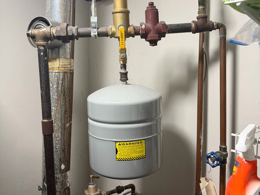 Expansion tank hanging from boiler piping, with a relief valve