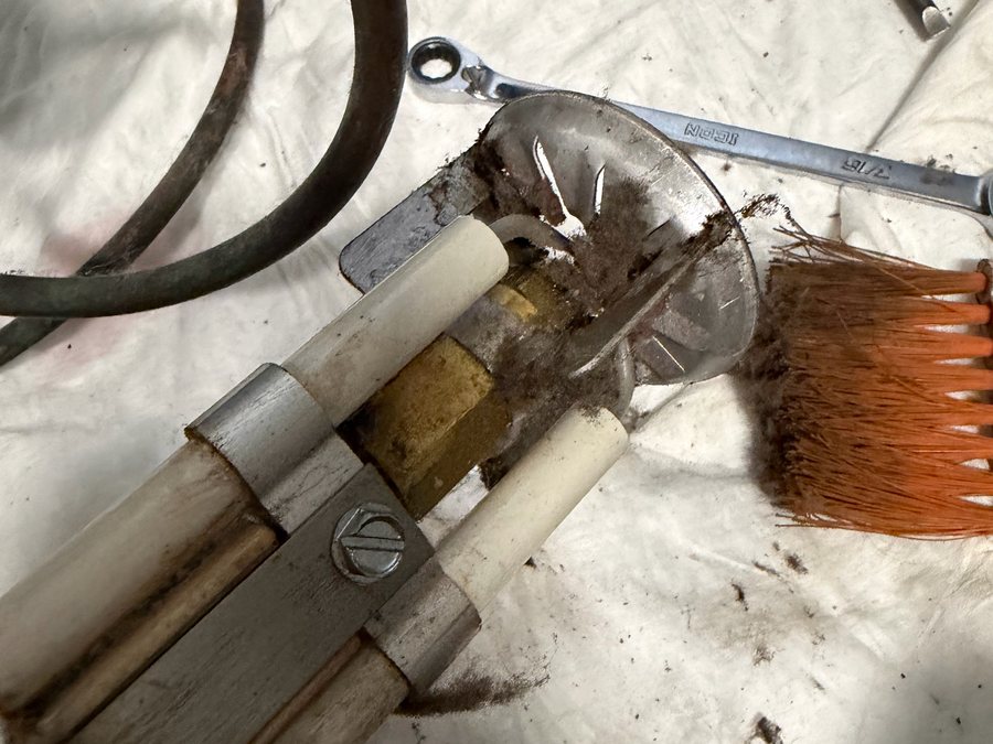 Dirty oil burner nozzle assembly removed for replacement