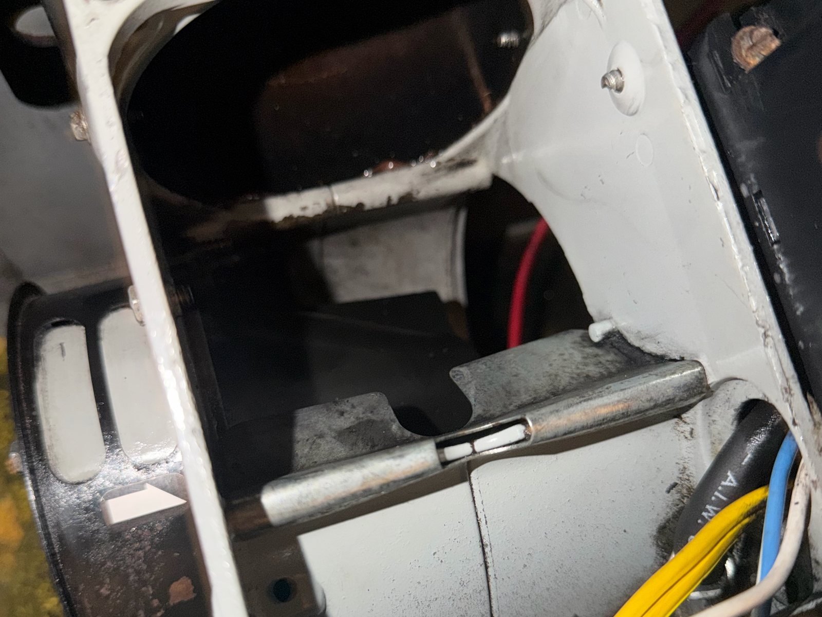 Oil burner opened up for service, with soot on the housing