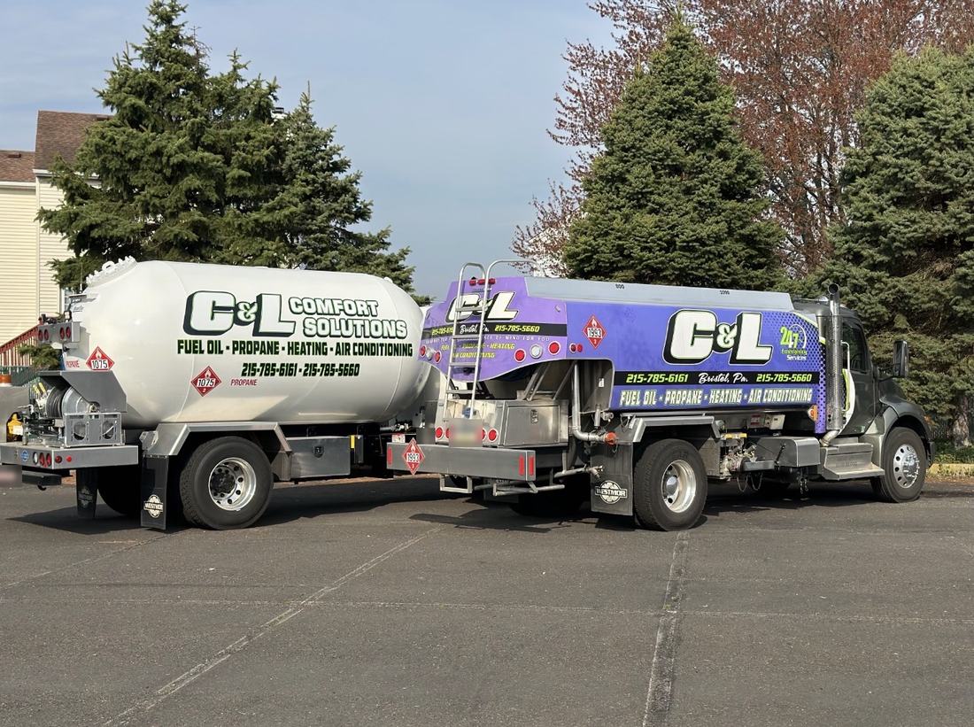 C&L Fuel heating oil delivery truck and white C&L propane delivery tank, seen from the rear