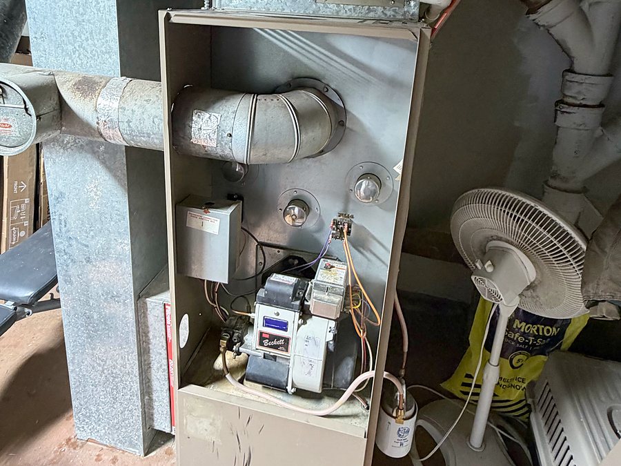 Oil furnace with the front panel off and the Beckett burner showing, ready for service