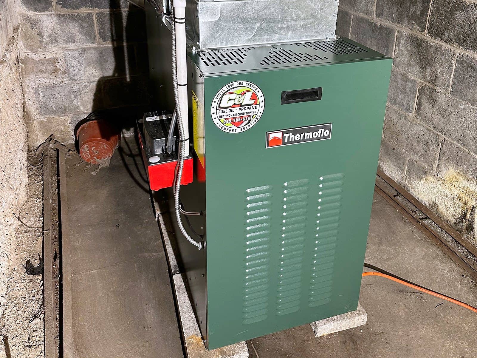 New Thermoflo oil furnace with the C&L sticker, installed in a basement
