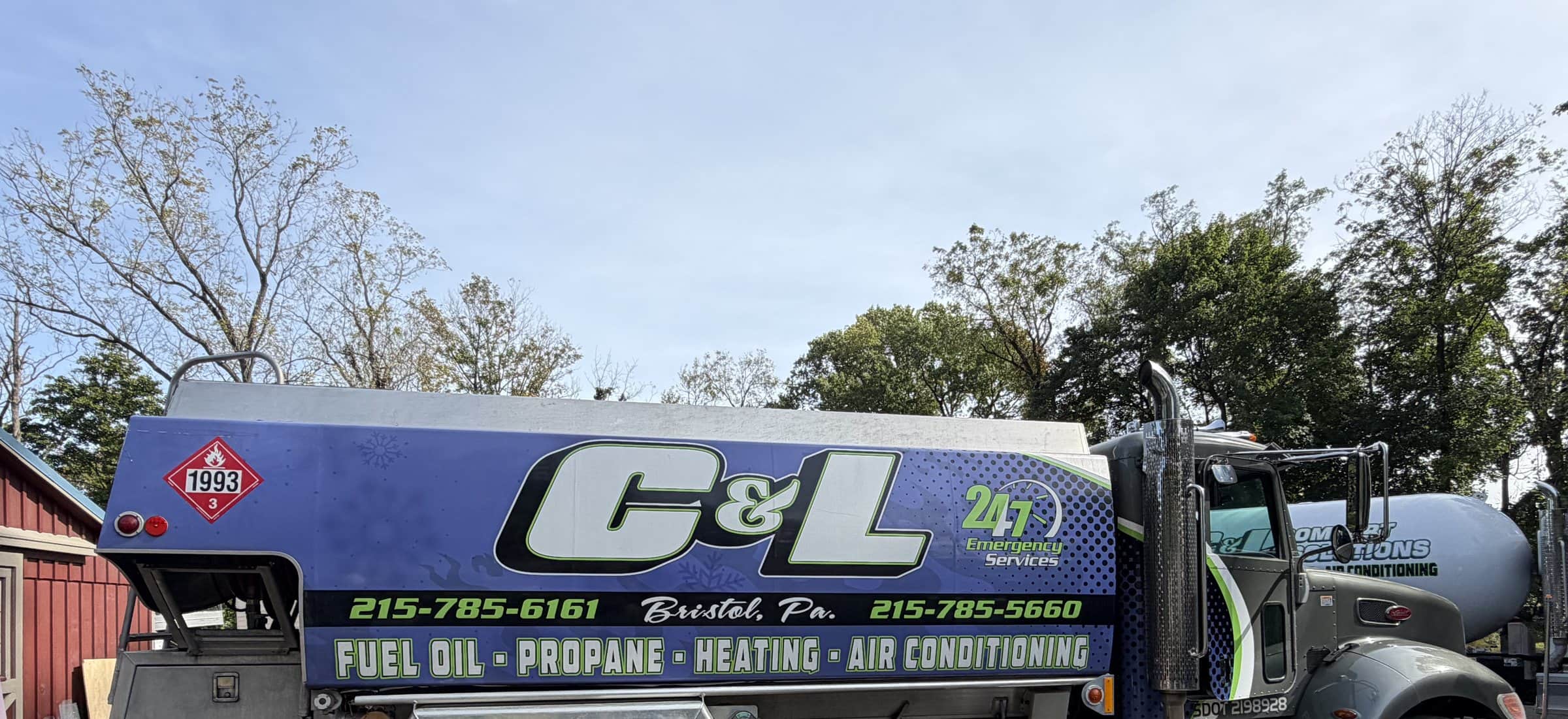 C&L Fuel heating oil delivery truck with its full C&L wrap, parked on gravel