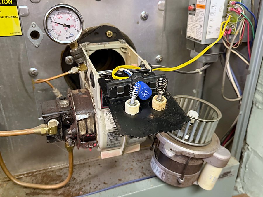 Oil burner pulled out for service, with the electrodes visible