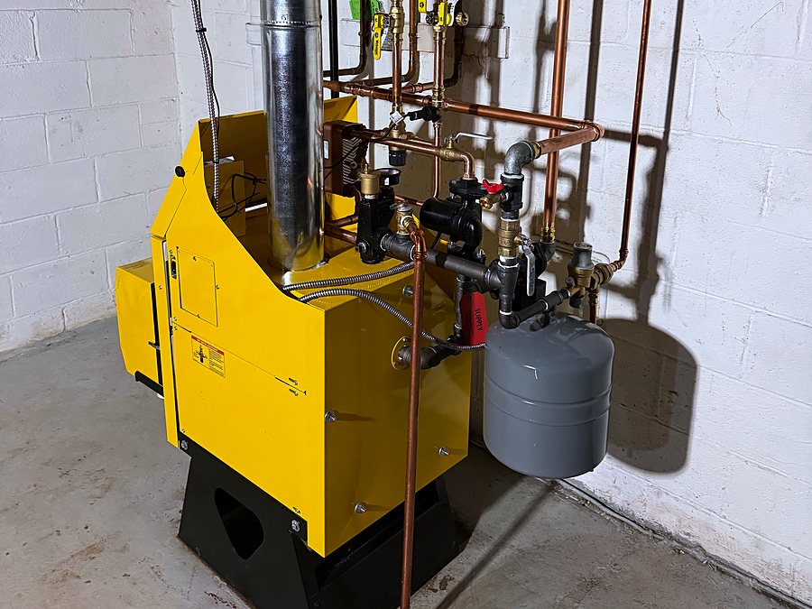Yellow Energy Kinetics Ascent boiler from the side, with an expansion tank and zone valves