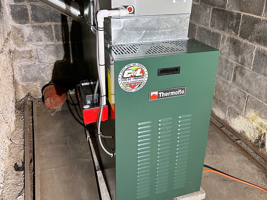 New Thermoflo oil furnace with the C&L sticker, installed in a basement