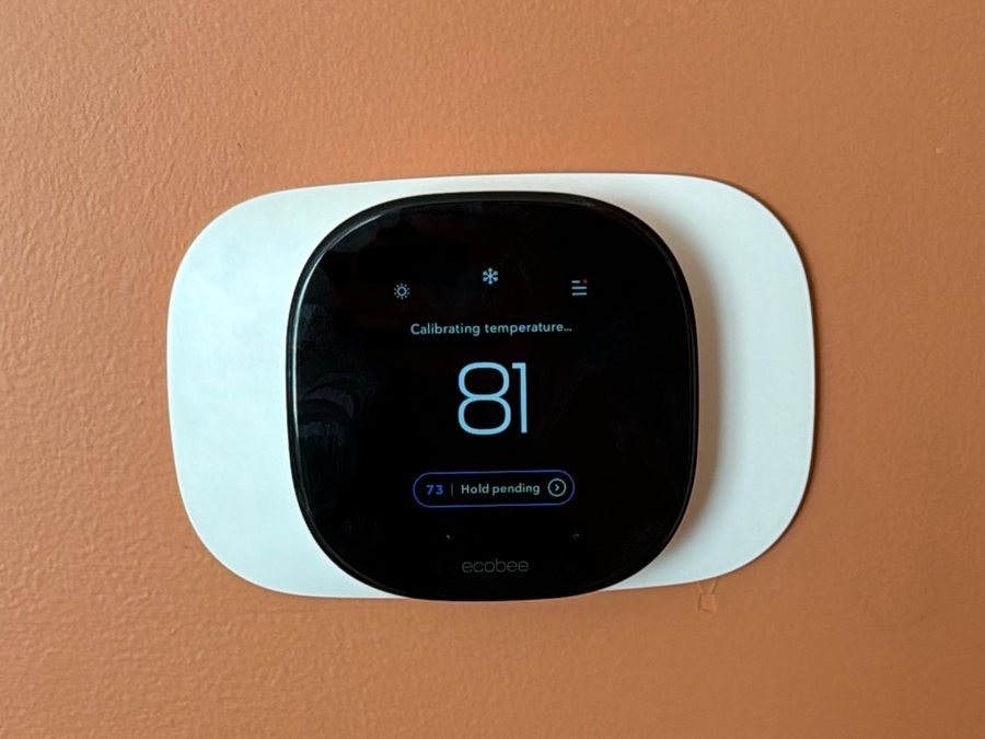 Smart thermostat mounted on a wall