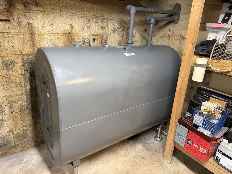 Gray indoor heating oil tank in a basement