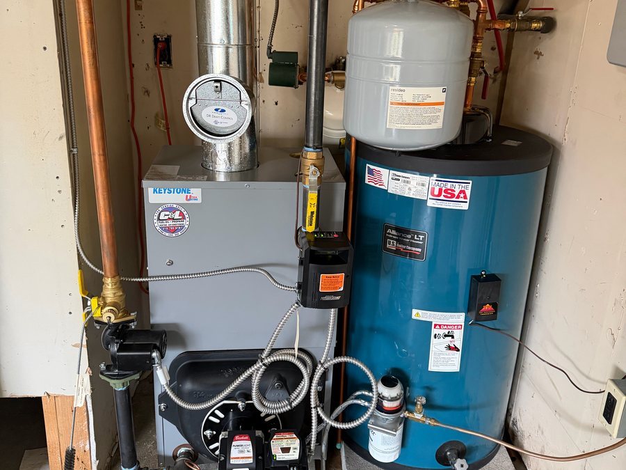 Oil boiler with an expansion tank and a water heater beside it