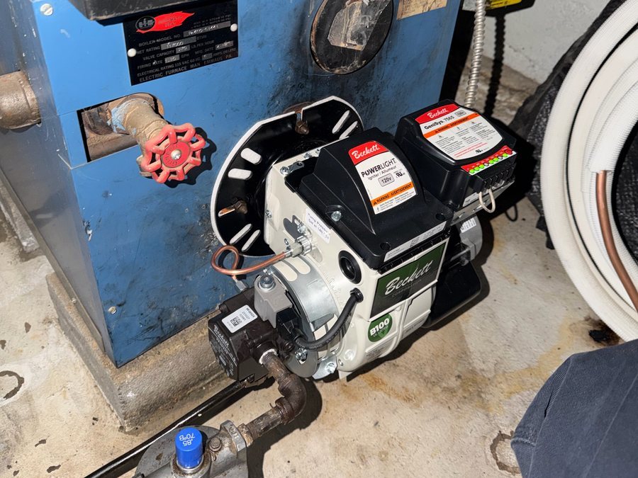 Oil burner mounted on a blue boiler